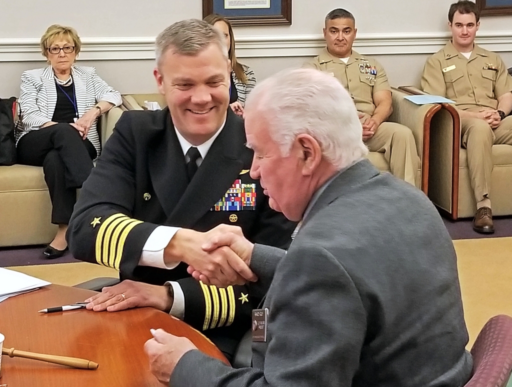 CAPT Jason Hammond and Commissioner president Randy Guy shake hands after signing agreement on the coordination of use of restricted airspace. (Photo: St. Mary's Co. Government)