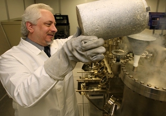 DAHLGREN, Va. - Dr. Kevin Boulais uses liquid nitrogen in a molecular beam epitaxy system to create photo capacitors for light guide film applications at Naval Surface Warfare Center Dahlgren Division (NSWCDD). Boulais - among 32 inventors honored at the NSWCDD Patent Awards ceremony on July 19, 2018 - was recognized for his work on a patented innovation called, 'Light Guide Film Control for Optically Tunable Metamaterials'. Dr. Francisco Santiago and Dr. Charles Mannix were also honored for their work on the invention which pairs light guide films with photo-sensitive or photo-reactive metamaterials. The warfighter is provided with an optically controlled electrical element having a wide range of uses. For example, the invention will secure communication without the communicator having to transmit and it will network electronics, sensors, and radiating elements in a similar fashion. The light guide film will also improve flexible electronics. In other words, there will be "no copper interconnects to break," said Boulais. (U.S. Navy photo by D. Kevin Elliott/Released)