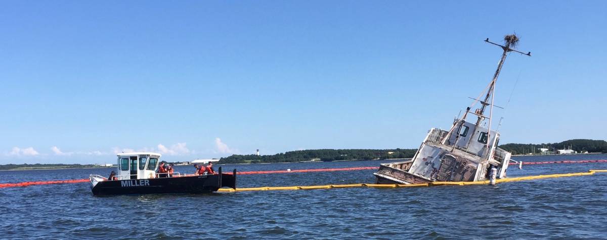 PATUXENT RIVER, Maryland (Aug. 30, 2018) - U.S. Coast Guard personnel and civilian contractors deploy a containment boom around a civilian-owned YP craft found to be leaking fuel in the Patuxent River since Aug. 28. NAS Patuxent River Port Operations Division successfully handed off containment and cleanup efforts to the U.S. Coast Guard Aug. 30 after two days of firstresponder containment. U.S. Navy photo (Released) 180830-N-JP566-002.