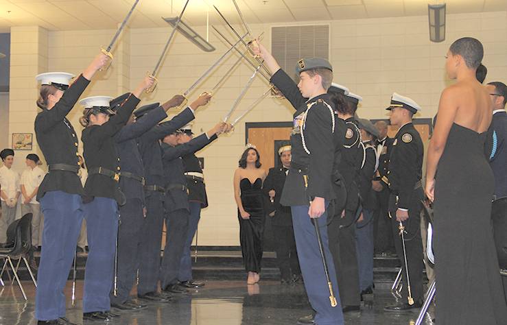 The king and queen of the ball -- Alexis Adame and Anna Scarafile, both Westlake High School seniors -- kick off the dancing after passing through a tradition saber arch formed by cadets from each school. (Submitted photo)