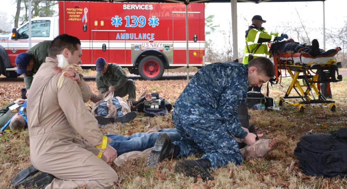 Hospital corpsmen from Naval Health Clinic Patuxent River assist multiple victims during a mock casualty scenario, part of last year's Citadel Shield/Solid Curtain 2018 anti-terrorism and force protection exercise. (U.S. Navy photo by Donna Cipolloni)