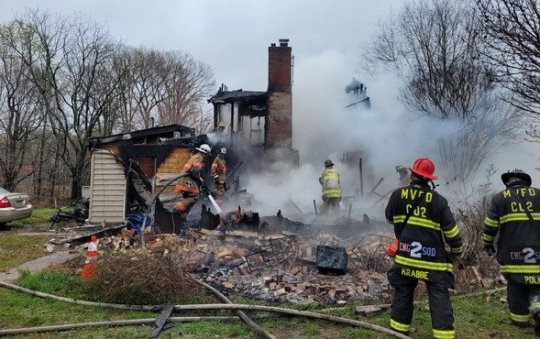 Firefighters work to extinguish the last of the fire that claimed the life of a 75 year-old woman and left her rescuer seriously injured. (Photo courtesy of fire marshal)
