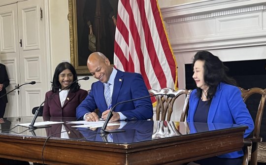Gov. Wes Moore signs executive orders releasing abortion training and other funds in his first full day in office. Lt. Gov. Aruna Miller and Secretary of State Susan Lee look on. (Photo: Michael Charles)